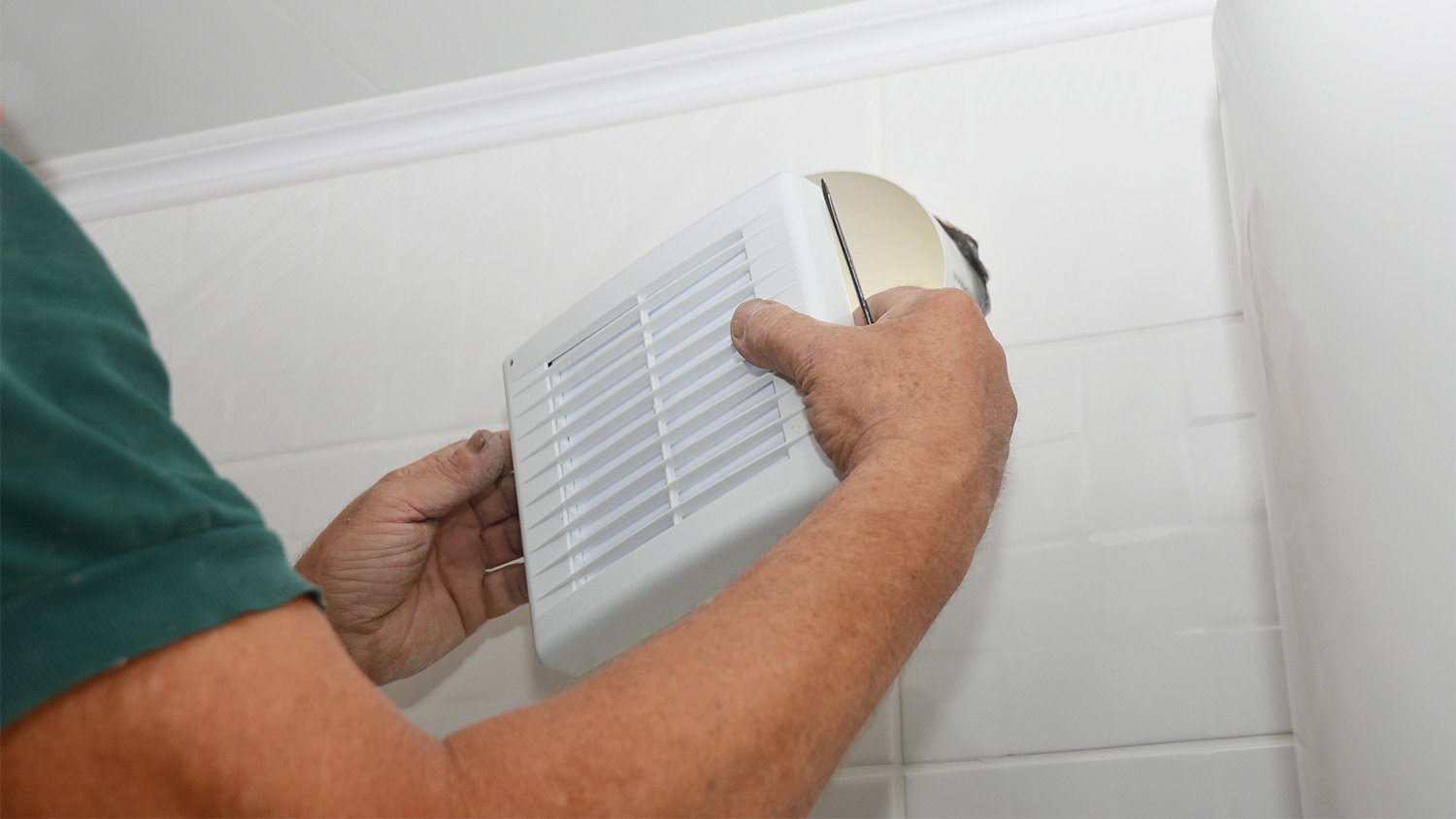 handyman installing bathroom vent